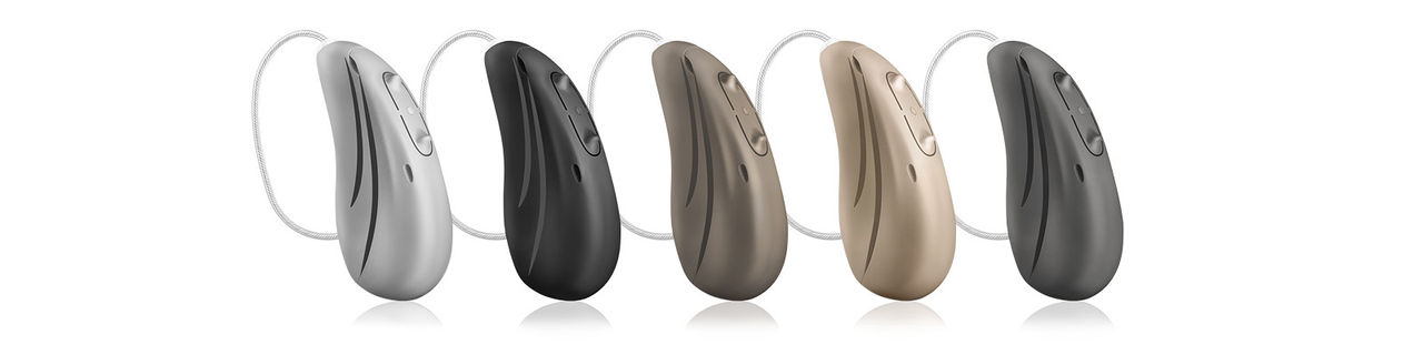 Hearing aids in five tone-in-tone colors: Sterling Silver, Metallic Anthracite, Carbon Black, Mocha Brown, and Cashmere Beige