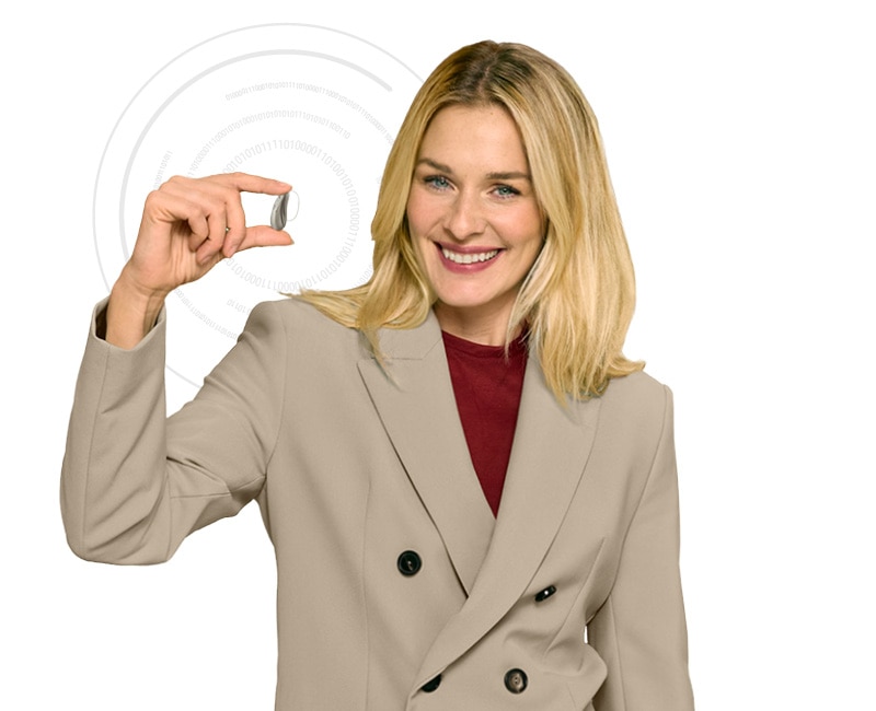 Person proudly holding a hearing aid toward the camera