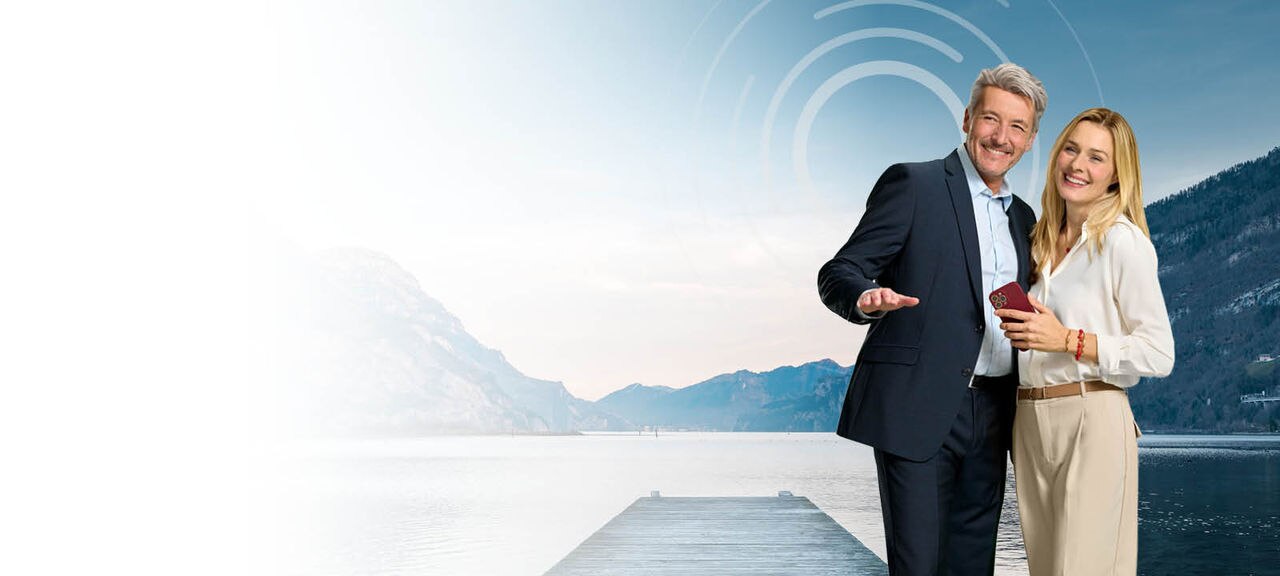 Couple in front of a lake with a pier 